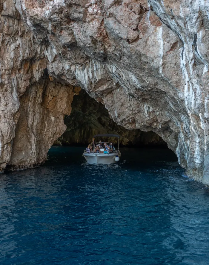 A small boat inside the arch of the Blue Cave