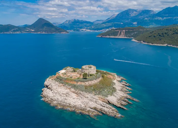 Round Mamula fortress on its island at the entrance to the bay