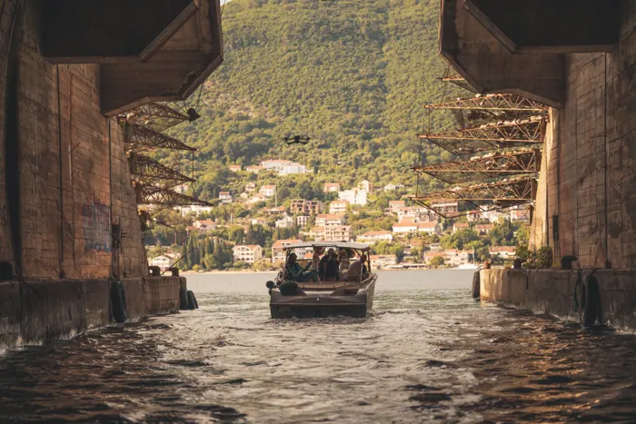 View out of a wartime submarine tunnel with a Limitless boat inside